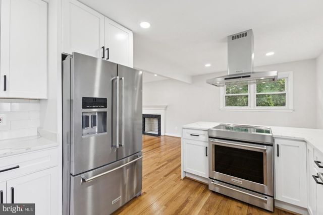 a kitchen with a stove refrigerator and microwave