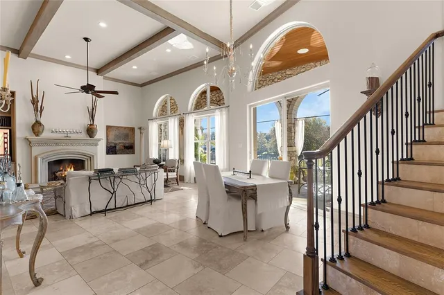 a living room with furniture a fireplace and a chandelier