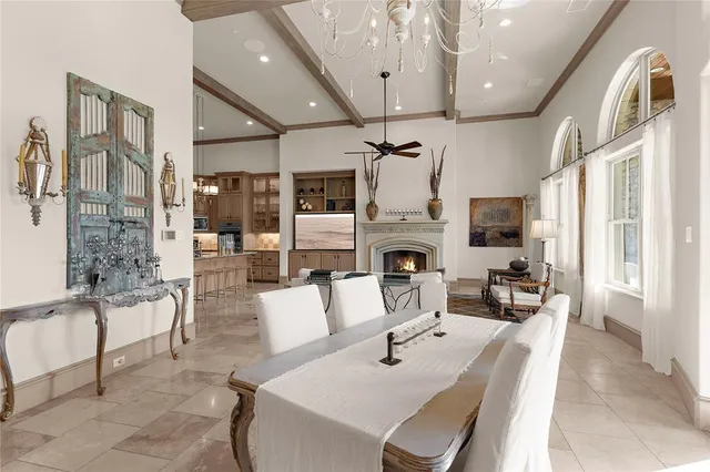 a living room with furniture a fireplace and a chandelier