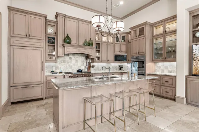 a kitchen with stainless steel appliances granite countertop a refrigerator and microwave