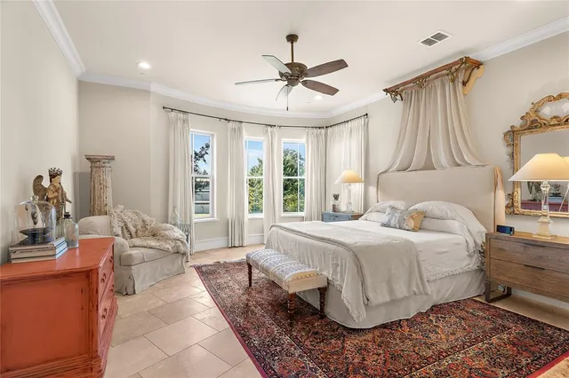 a bedroom with a large bed and a window