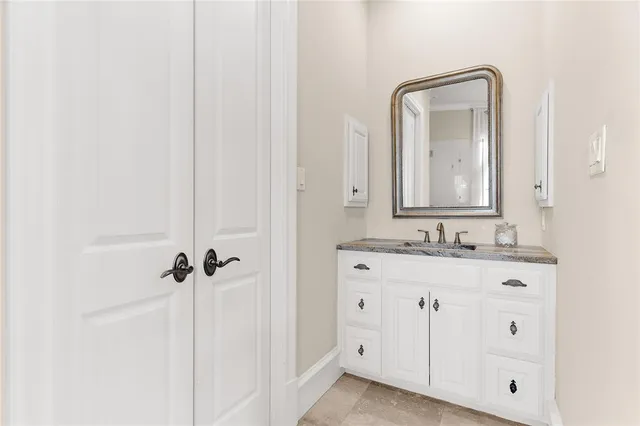 a bathroom with a double vanity sink and mirror