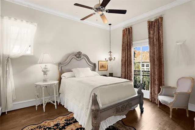 a bedroom with a bed a rug and wooden floor