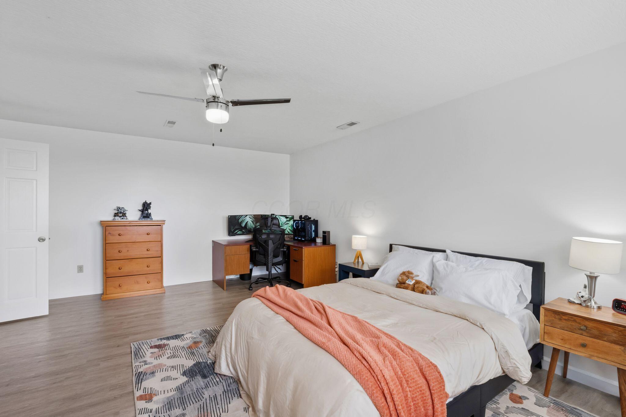 10446 Rich Hollow Road Southwest Lancaster, OH 43130 - Photo 52 of 83 Spacious room featuring wood-finish flooring, white walls, and a ceiling fan with integrated lighting