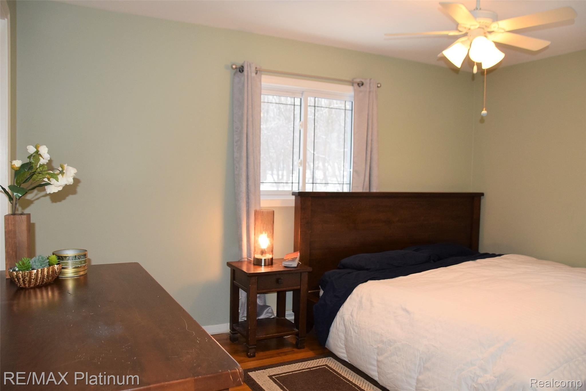 11503 Center Road Fenton, MI 48430 - Photo 12 of 25 master bedroom wood floors 2 windows.JPG