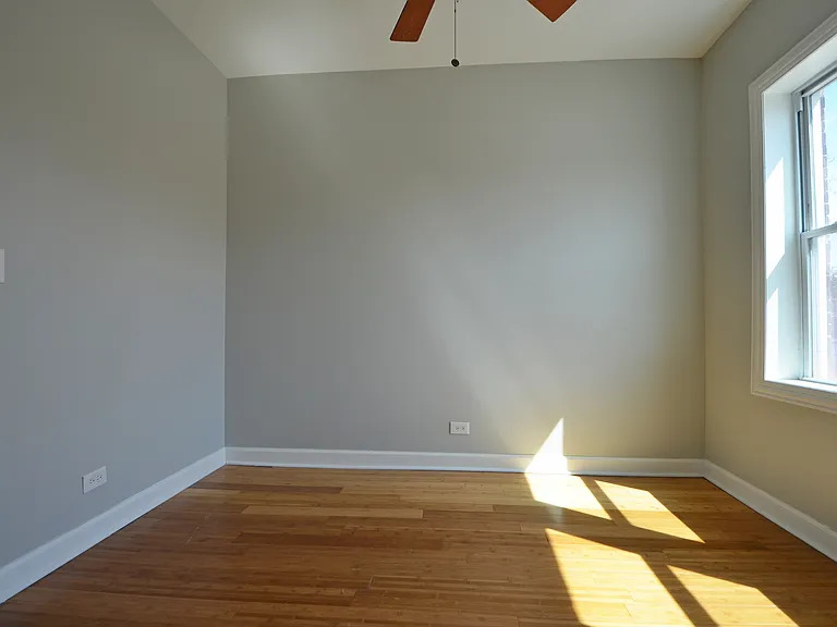 1922 West 47th Street, Unit 2 Chicago, IL 60609 - Photo 11 of 20 a view of an empty room with wooden floor and a window