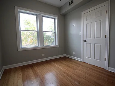 1922 West 47th Street, Unit 2 Chicago, IL 60609 - Photo 14 of 20 a view of an empty room with wooden floor and a window