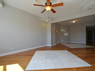 1922 West 47th Street, Unit 2 Chicago, IL 60609 - Photo 4 of 20 a view of a room with wooden floor and a ceiling fan