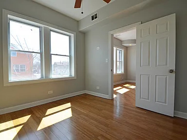 1922 West 47th Street, Unit 2 Chicago, IL 60609 - Photo 9 of 20 a view of empty room with wooden floor and fan