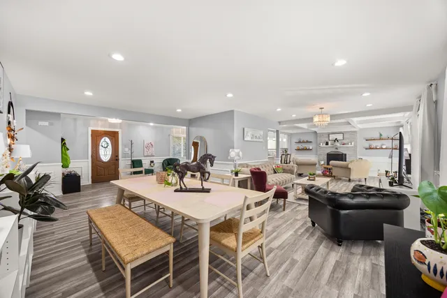 a living room with lots of furniture and kitchen view