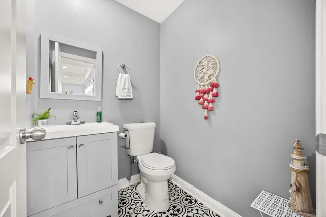 a bathroom with a sink mirror vanity and toilet