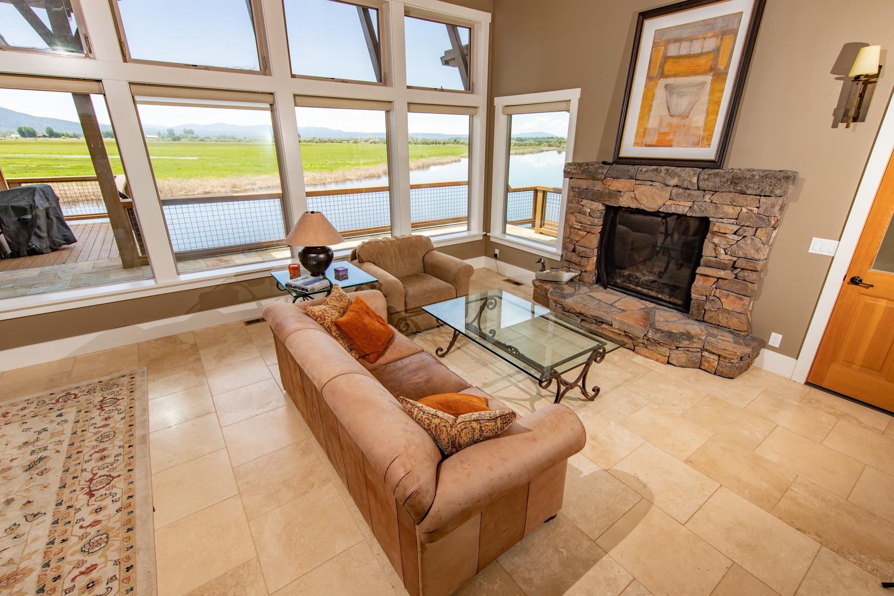 42369 Horr Road Fall River Mills, CA 96028 - Photo 15 of 21 a living room with furniture large window and a fireplace