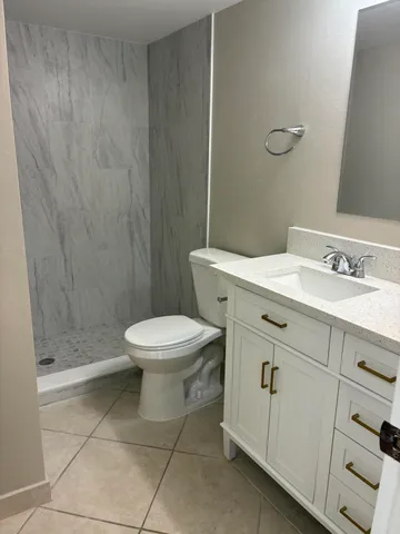 a bathroom with a sink a toilet and a shower