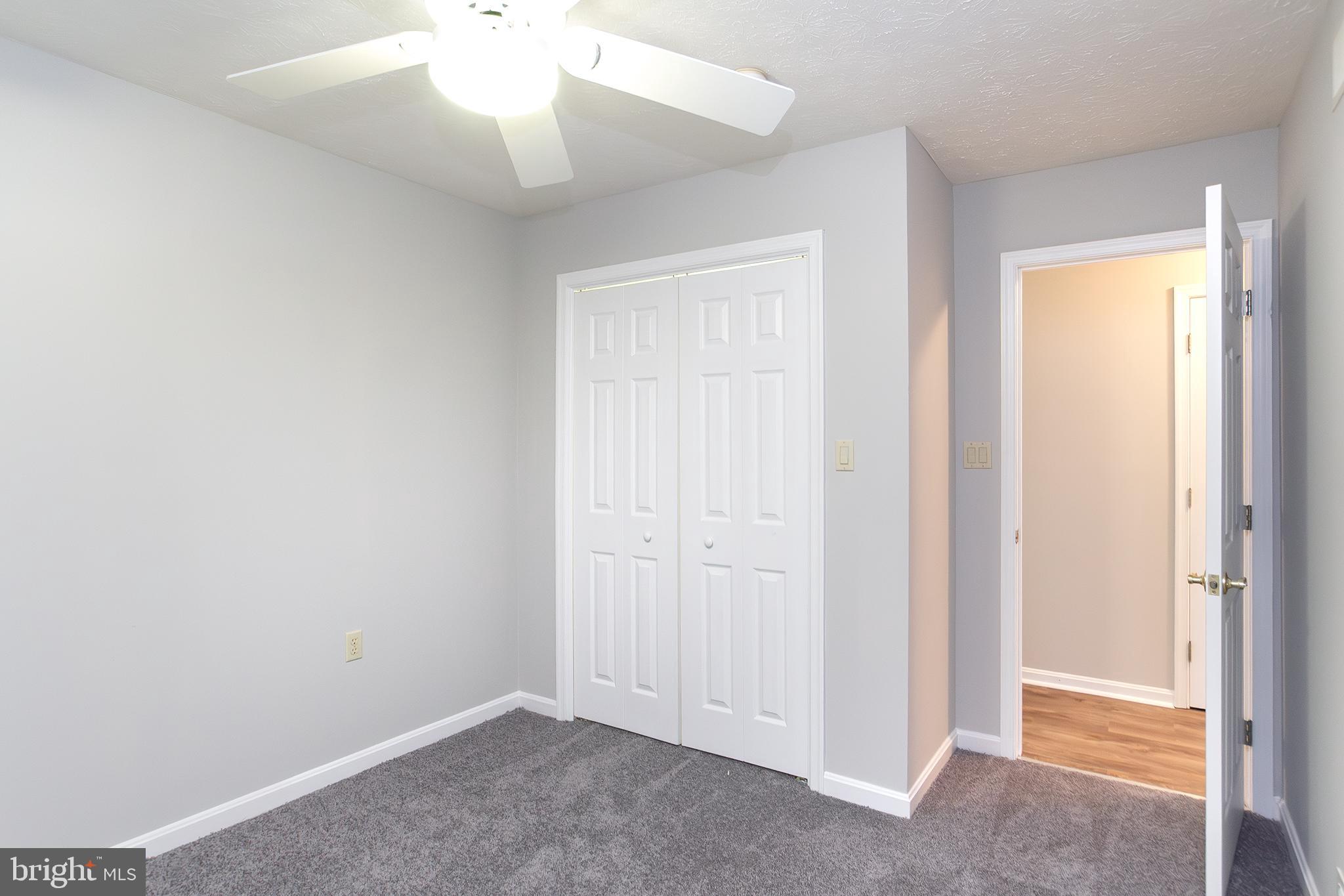 19930 Old York Road White Hall, MD 21161 - Photo 17 of 46 an empty room with a ceiling fan and a window