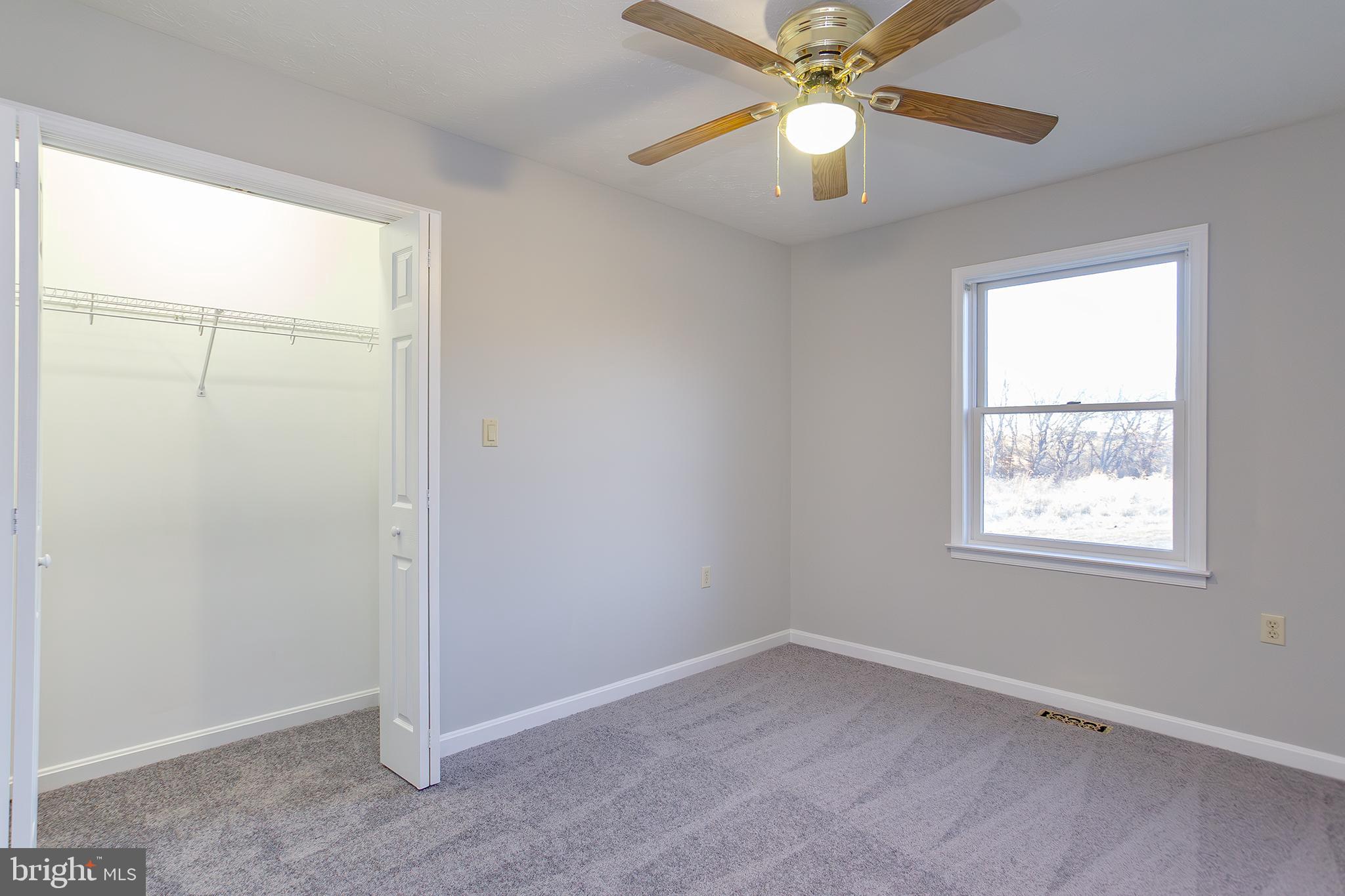 19930 Old York Road White Hall, MD 21161 - Photo 18 of 46 an empty room with a window and a fan