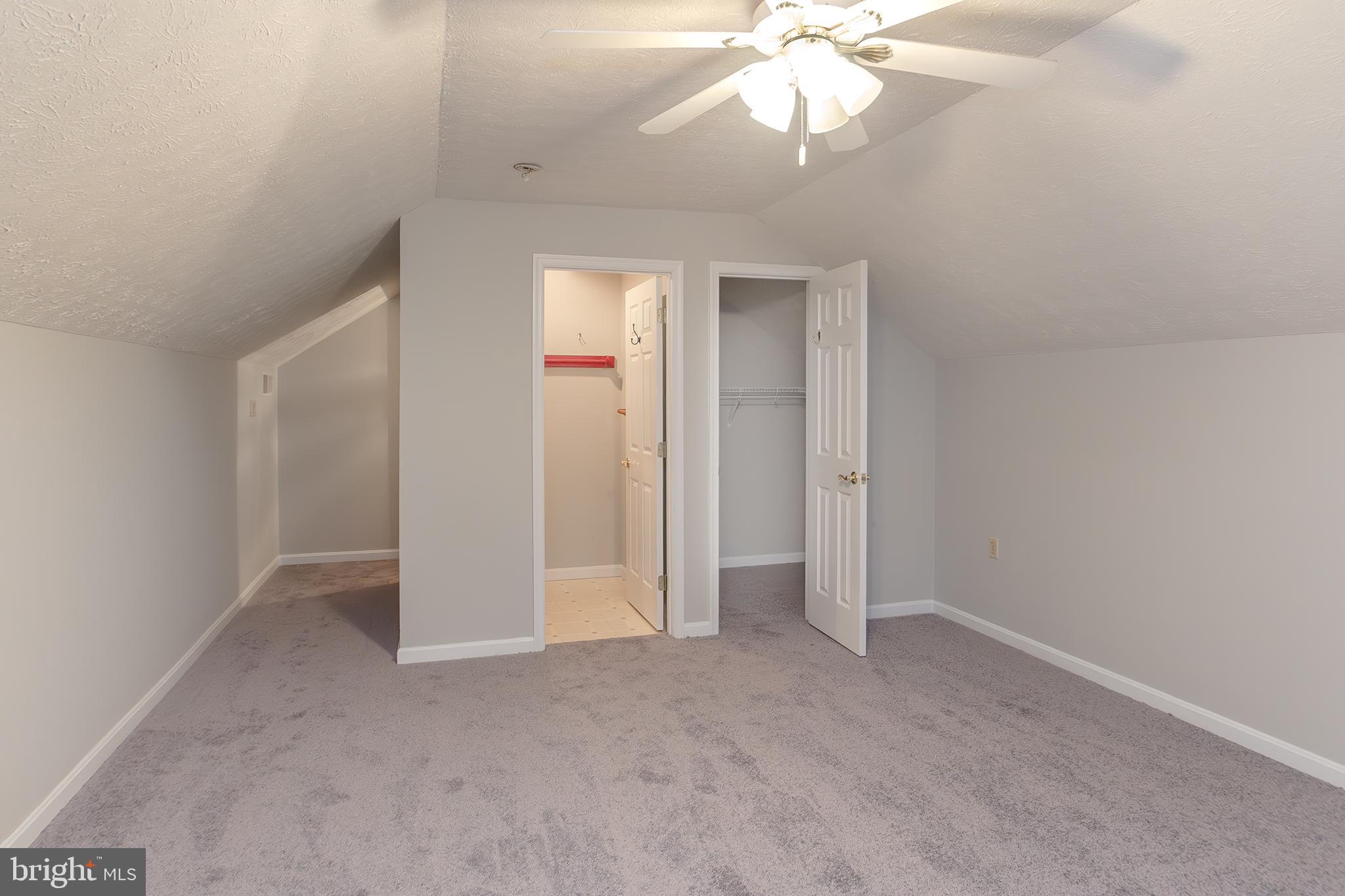 19930 Old York Road White Hall, MD 21161 - Photo 25 of 46 an empty room with a chandelier fan and windows