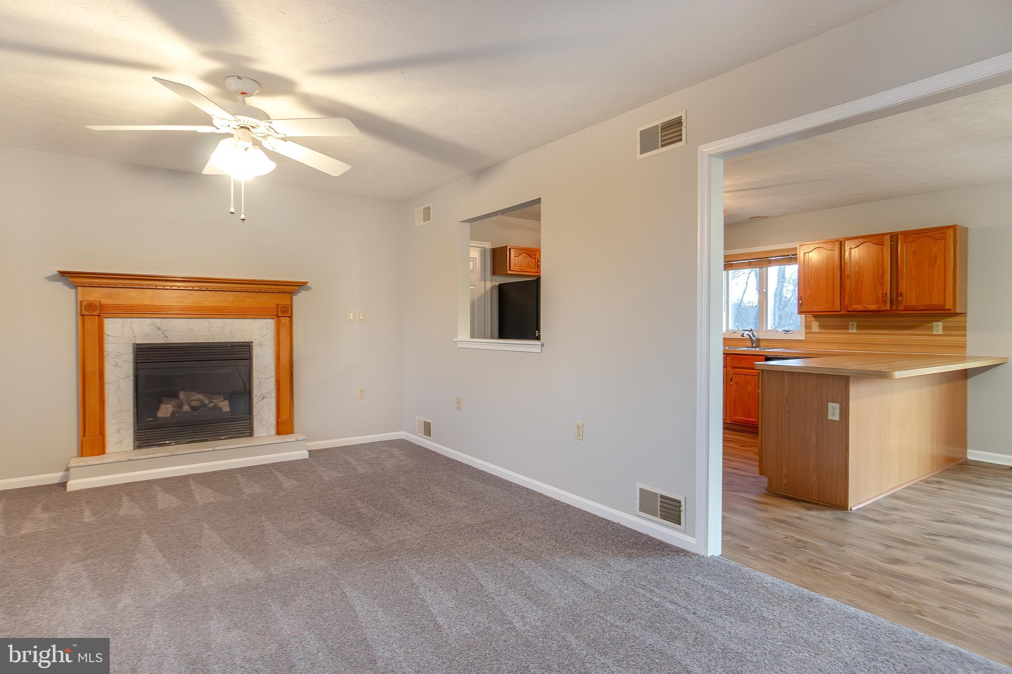 19930 Old York Road White Hall, MD 21161 - Photo 6 of 46 a view of an empty room with window and fireplace