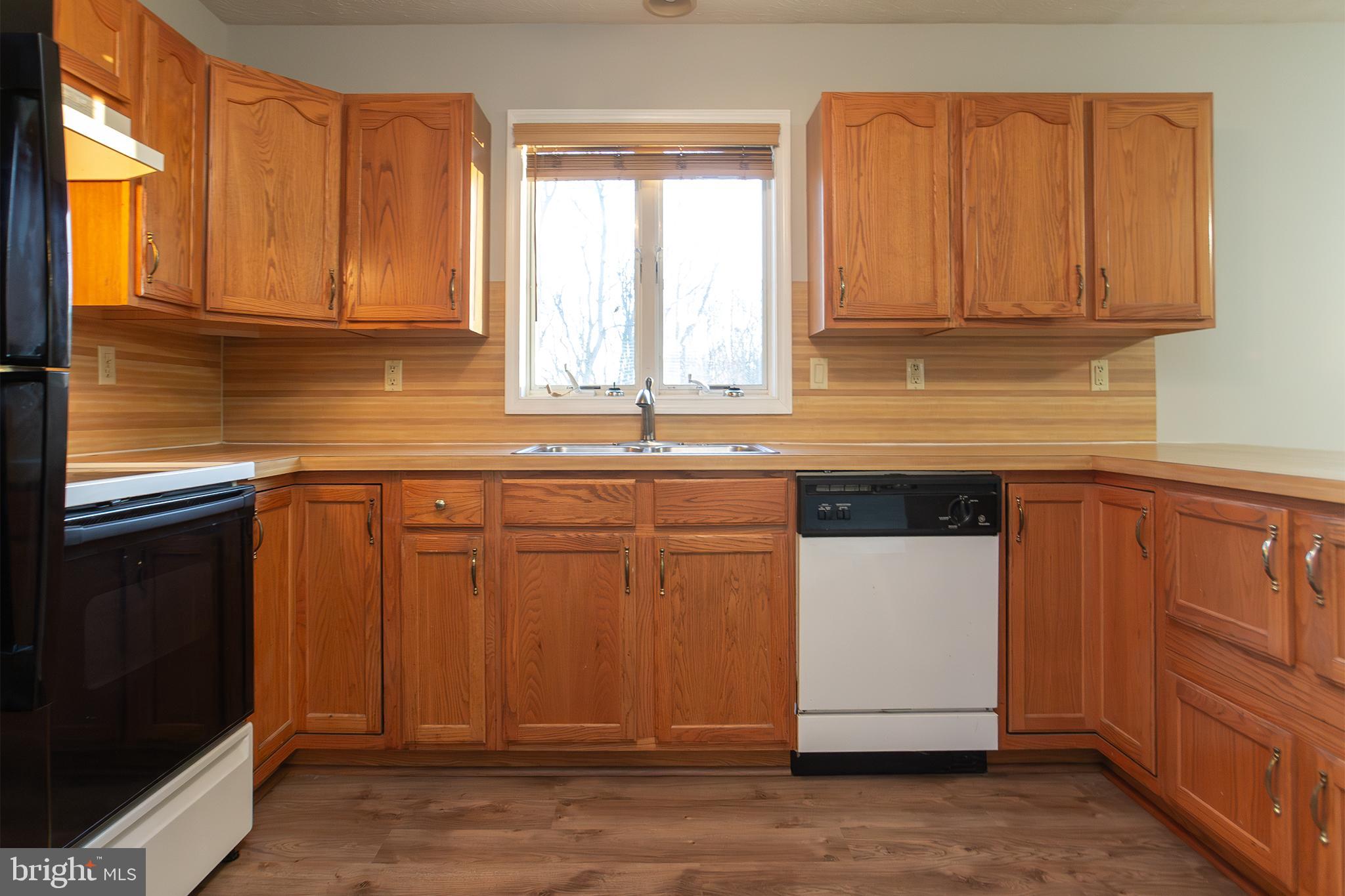 19930 Old York Road White Hall, MD 21161 - Photo 8 of 46 a kitchen with granite countertop wooden cabinets stainless steel appliances a sink and a window
