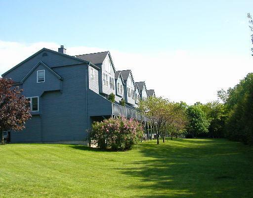 53 Fawn Ridge Lane, Unit 53 Wilton, CT 06897 - Photo 1 of 1 a view of a big house with a big yard and potted plants