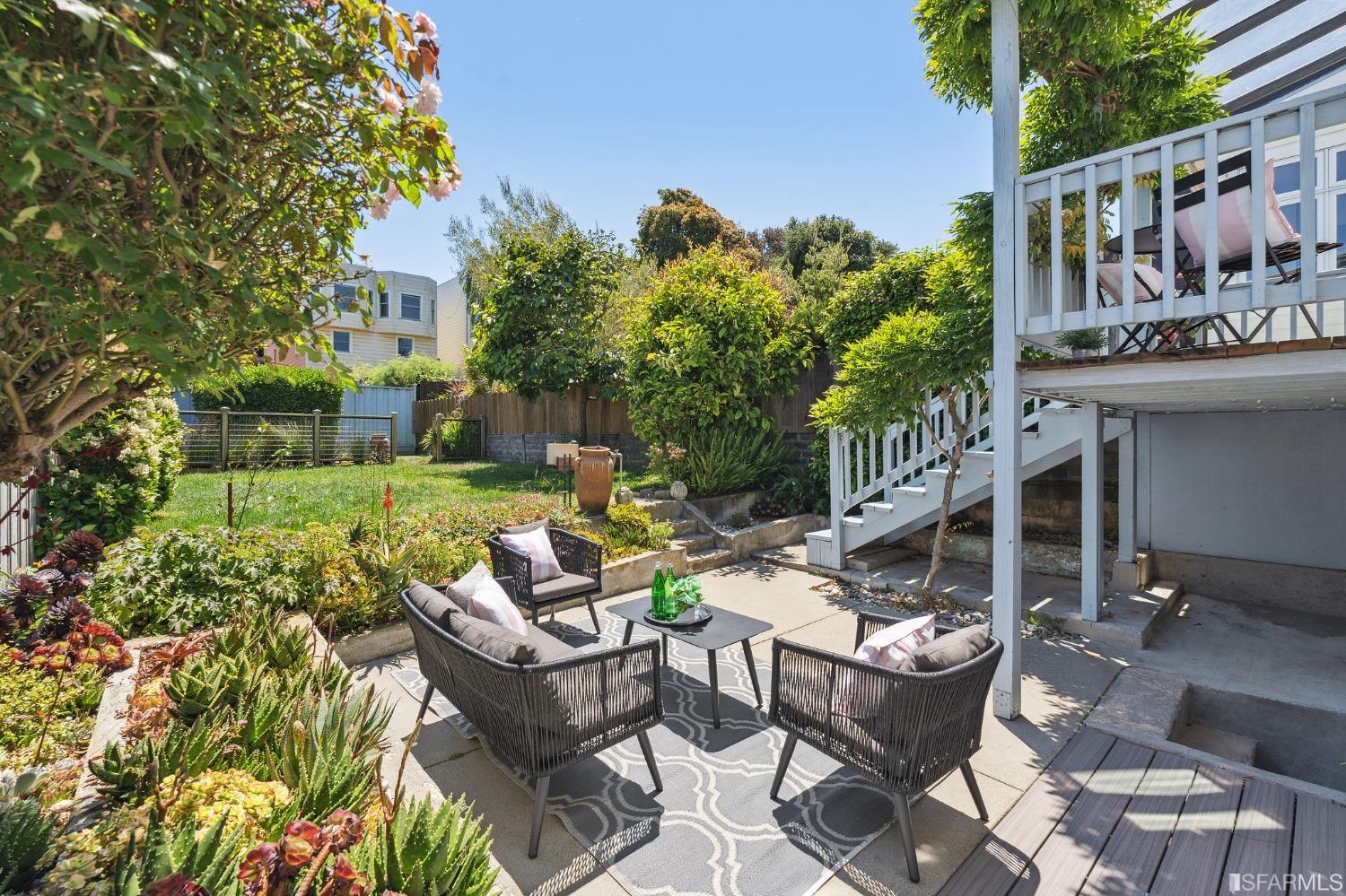 445 Clipper Street San Francisco, CA 94114 - Photo 18 of 62 a view of a patio with table and chairs and potted plants