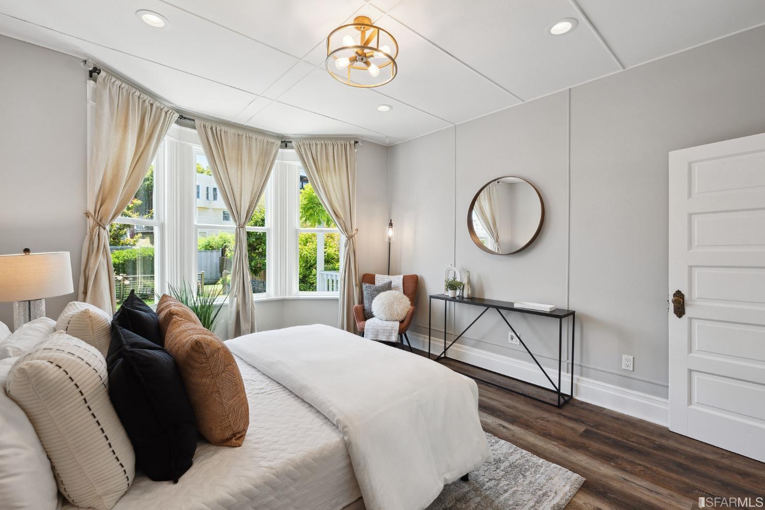 445 Clipper Street San Francisco, CA 94114 - Photo 25 of 62 a bedroom with a bed a window and a chandelier