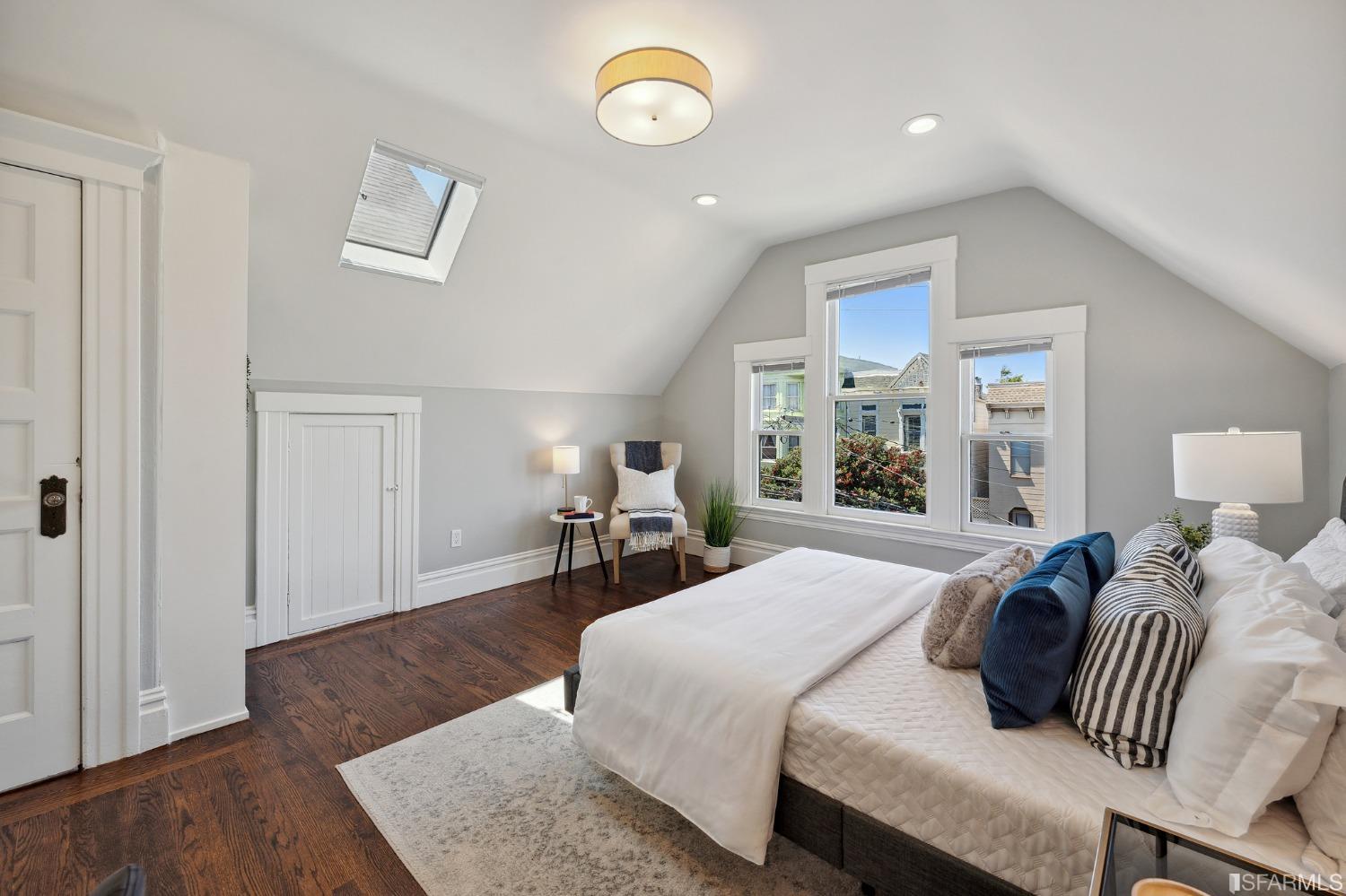 445 Clipper Street San Francisco, CA 94114 - Photo 36 of 62 a bedroom with a bed and wooden floor