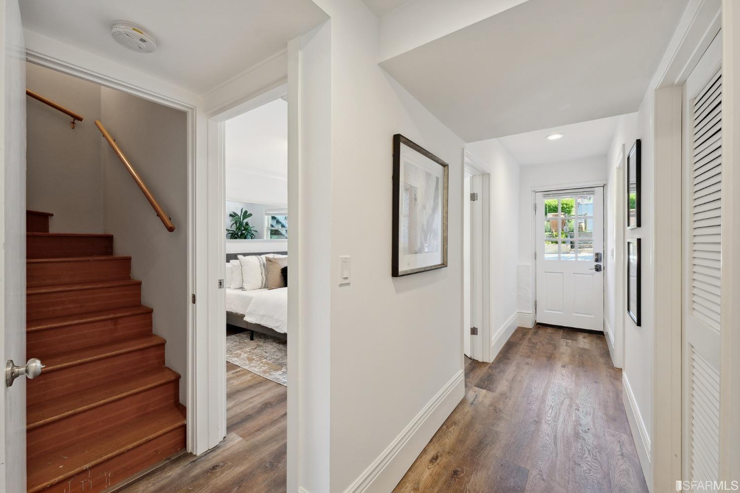 445 Clipper Street San Francisco, CA 94114 - Photo 40 of 62 a view of a hallway with wooden floor and staircase