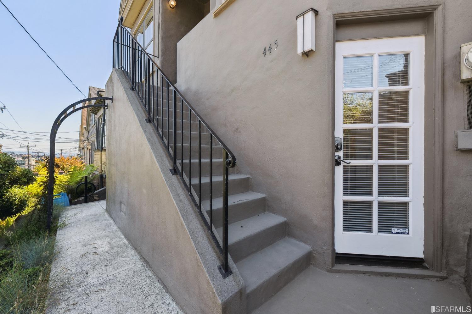 445 Clipper Street San Francisco, CA 94114 - Photo 41 of 62 a view of staircase with white walls and windows
