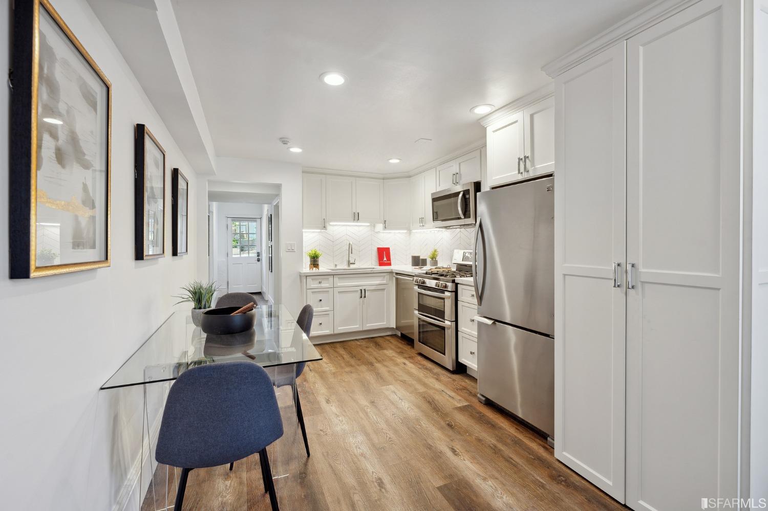 445 Clipper Street San Francisco, CA 94114 - Photo 46 of 62 a kitchen with a refrigerator a sink and cabinets