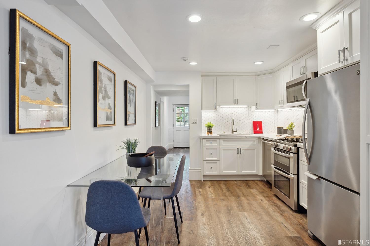 445 Clipper Street San Francisco, CA 94114 - Photo 47 of 62 a kitchen with stainless steel appliances a refrigerator a stove a sink dishwasher a dining table and chairs with wooden floor
