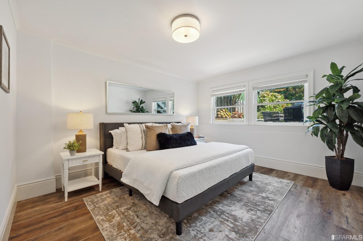 445 Clipper Street San Francisco, CA 94114 - Photo 51 of 62 a bedroom with a large bed and a potted plant