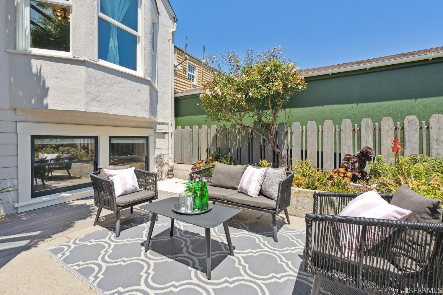 445 Clipper Street San Francisco, CA 94114 - Photo 57 of 62 a view of a patio with a dining table and chairs with wooden floor