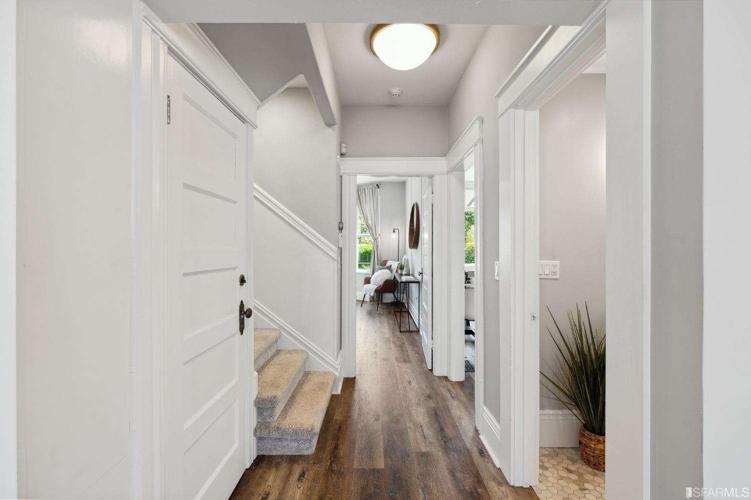 445 Clipper Street San Francisco, CA 94114 - Photo 10 of 62 a view of a hallway with wooden floor and staircase