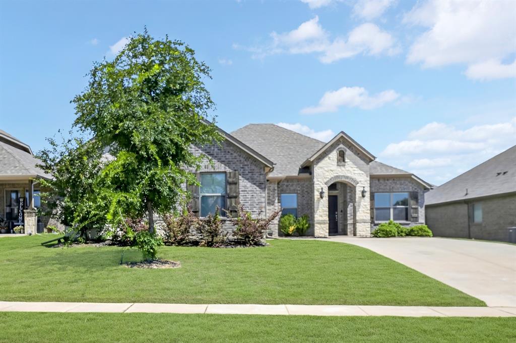136 Gleeson Drive Red Oak, TX 75154 - Photo 2 of 40 a front view of a house with a garden and plants
