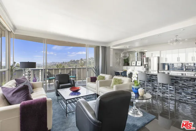 a living room with furniture and a floor to ceiling window