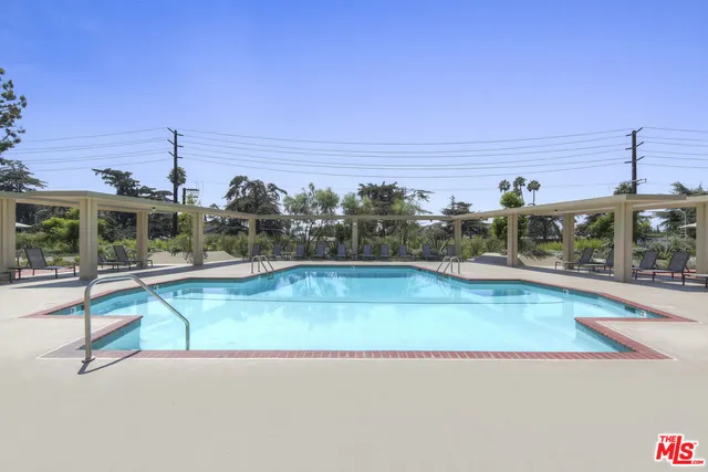 a front view of a house with a tree