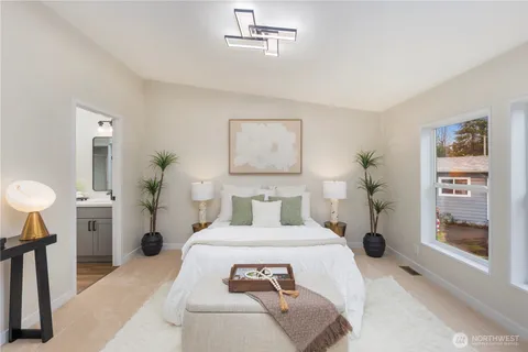 a bedroom with a large bed and a window