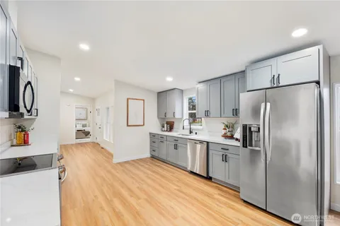 a large kitchen with a refrigerator a sink dishwasher and a refrigerator