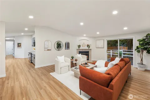 a living room with furniture and a wooden floor