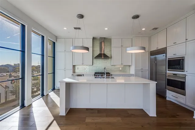 a open kitchen with stainless steel appliances granite countertop a stove and a sink