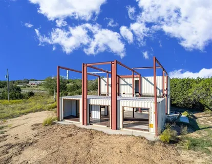 a view of a house with backyard porch and sitting area