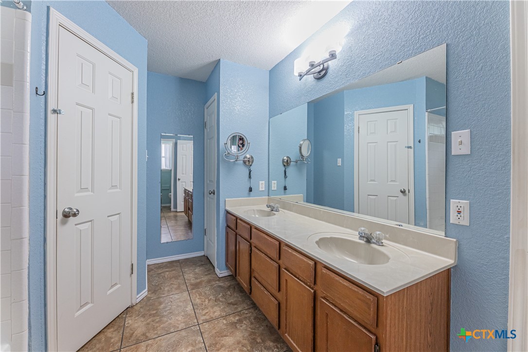 2405 Thoroughbred Drive Killeen, TX 76549 - Photo 17 of 31 a bathroom with a sink and a mirror