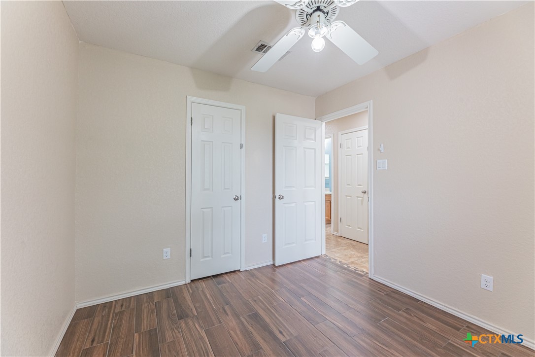 2405 Thoroughbred Drive Killeen, TX 76549 - Photo 26 of 31 an empty room with wooden floor and fan