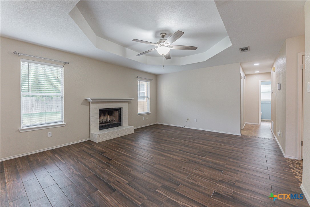 2405 Thoroughbred Drive Killeen, TX 76549 - Photo 8 of 31 a view of an empty room with wooden floor fireplace and a window