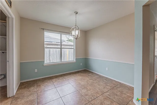a room that has a window and a chandelier
