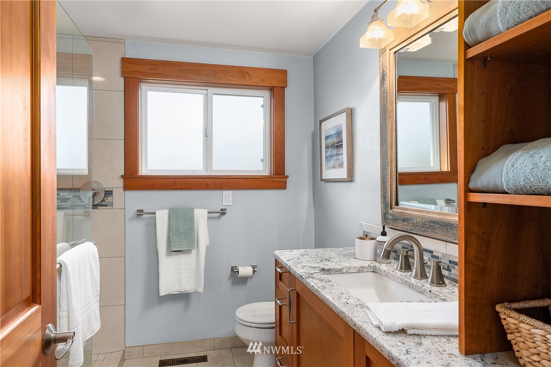 7139 South Sunnycrest Road Seattle, WA 98178 - Photo 12 of 28 a bathroom with a granite countertop sink toilet and mirror