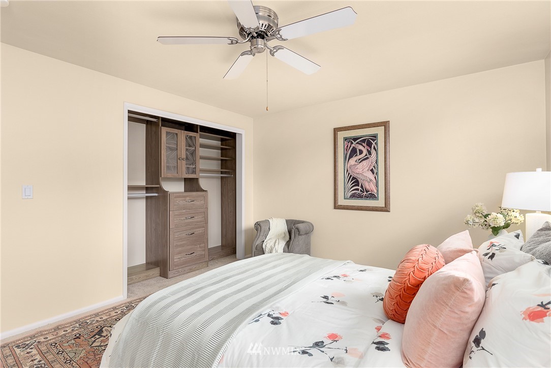 7139 South Sunnycrest Road Seattle, WA 98178 - Photo 13 of 28 a bedroom with a bed and a chandelier