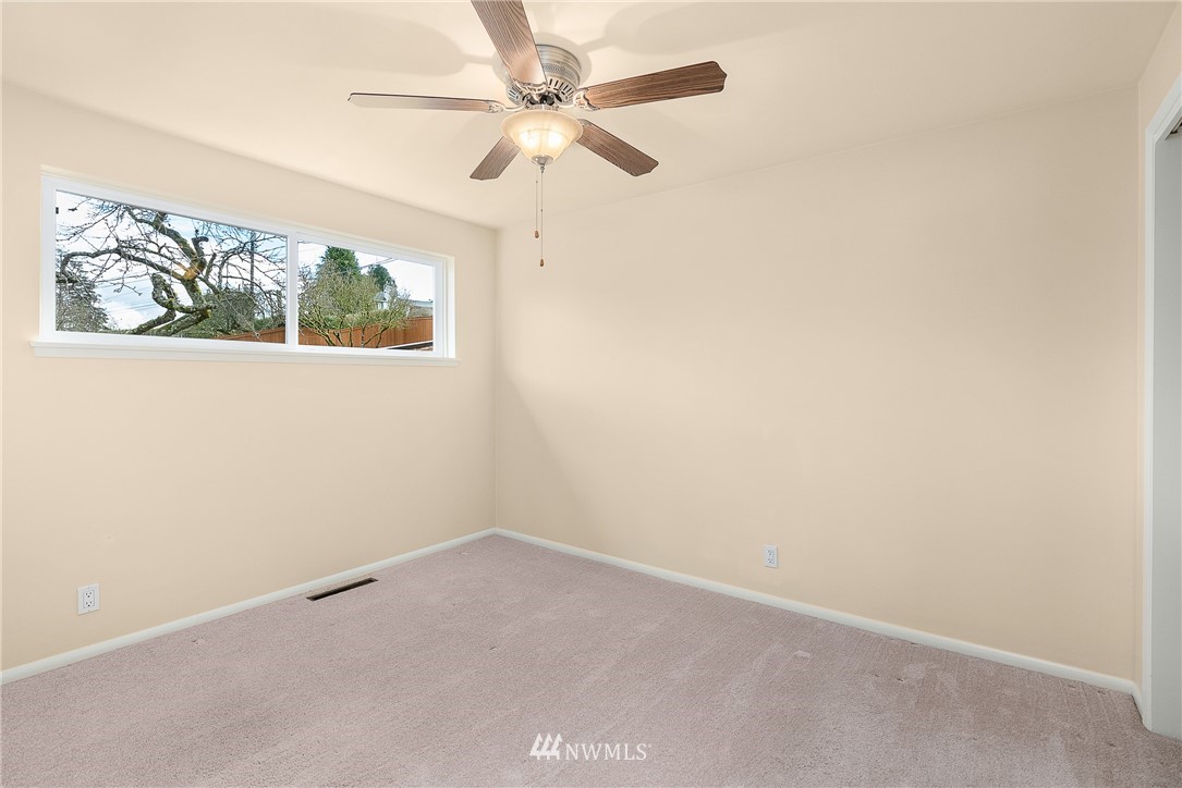 7139 South Sunnycrest Road Seattle, WA 98178 - Photo 16 of 28 an empty room with a window and a fan