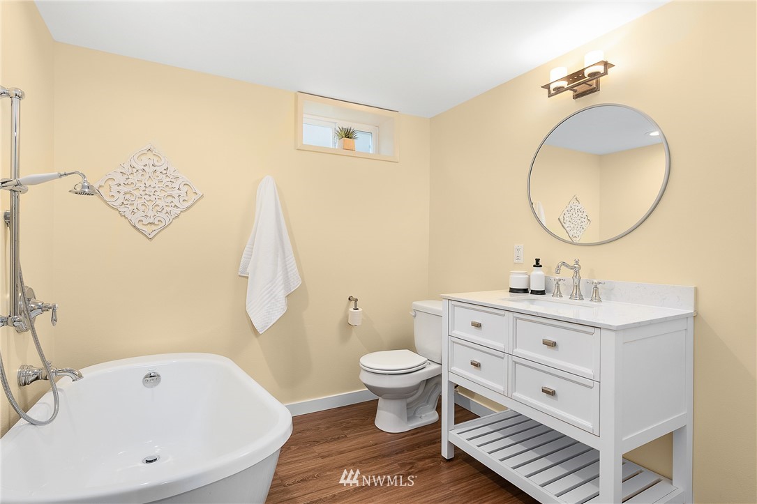 7139 South Sunnycrest Road Seattle, WA 98178 - Photo 24 of 28 a bathroom with a sink a toilet and a mirror