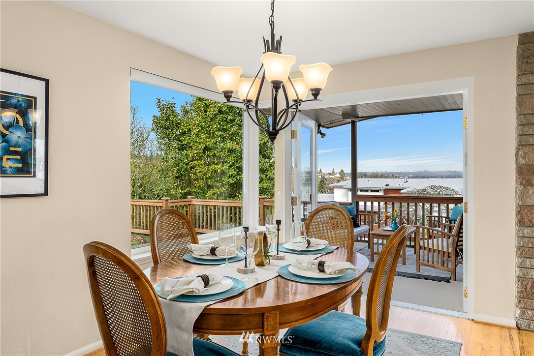 7139 South Sunnycrest Road Seattle, WA 98178 - Photo 6 of 28 a dining room with furniture a chandelier and wooden floor